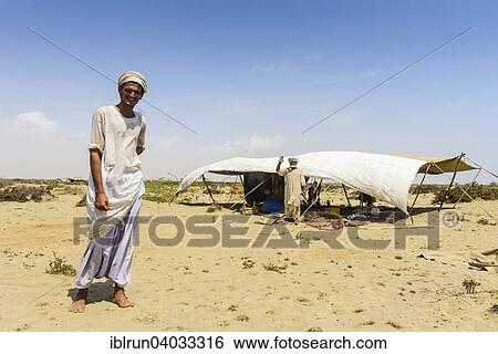 "Rashaida man standing in front of his tent in the desert around Massaua, Eritrea, Africa" View Large Photo Image Stock Photograph - "Rashaida man standing in front of his tent in the desert around Massaua, Eritrea, Africa". Fotosearch