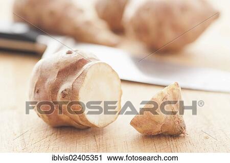 Raw Jerusalem artichokes (Helianthus tuberosus) and a knife on a cutting board View Large Photo Image Stock Image - Raw Jerusalem artichokes (Helianthus tuberosus) and a knife on a cutting board. Fotosearch