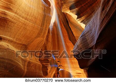 Stock Image - "Rays of light falling on yellow-red sandstone formations, Upper Antelope Canyon, near Page, Arizona, USA". Fotosearch