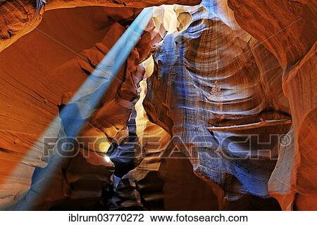 Stock Image - "Rays of light falling on yellow-red sandstone formations, Upper Antelope Canyon, near Page, Arizona, USA". Fotosearch