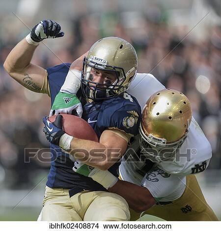 "RB Bo Snelson, #4 Navy, is tackled during the NCAA football game between the Navy and the Notre Dame on September 1, 2012 in Dublin, Ireland, Europe" View Large Photo Image Picture - "RB Bo Snelson, #4 Navy, is tackled during the NCAA football game between the Navy and the Notre Dame on September 1, 2012 in Dublin, Ireland, Europe". Fotosearch