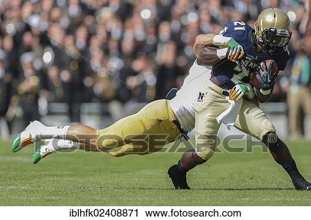"RB Greene Gee Gee, #21 Navy, runs with the ball during the NCAA football game between the Navy and the Notre Dame on September 1, 2012 in Dublin, Ireland, Europe" View Large Photo Image Stock Image - "RB Greene Gee Gee, #21 Navy, runs with the ball during the NCAA football game between the Navy and the Notre Dame on September 1, 2012 in Dublin, Ireland, Europe". Fotosearch