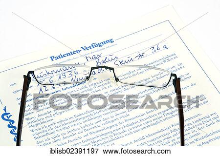 Stock Photo - Reading glasses lying on a German patient's provision. Fotosearch
