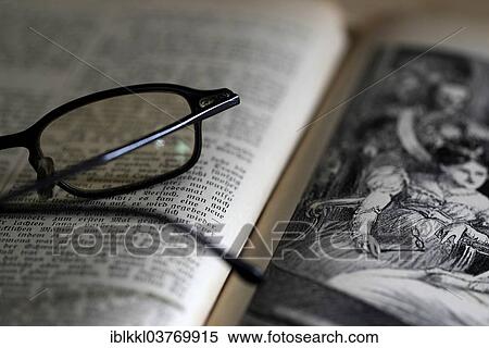 Stock Photography - Reading glasses lying on an old book. Fotosearch