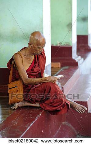 "Reading monk sitting between the pillars of the Shwedagon Pagoda in Yangon, Myanmar, Burma, Southeast Asia, Asia" View Large Photo Image Stock Image - "Reading monk sitting between the pillars of the Shwedagon Pagoda in Yangon, Myanmar, Burma, Southeast Asia, Asia". Fotosearch