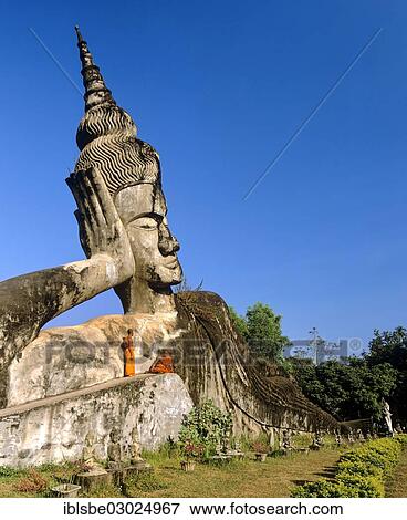 "Reclining Buddha, monks on the sculpture, in Xieng Khuan Buddha Park, Suan Xieng Khuan, Vientiane, Vientiane Province, Laos, Asia" View Large Photo Image Stock Photo - "Reclining Buddha, monks on the sculpture, in Xieng Khuan Buddha Park, Suan Xieng Khuan, Vientiane, Vientiane Province, Laos, Asia". Fotosearch