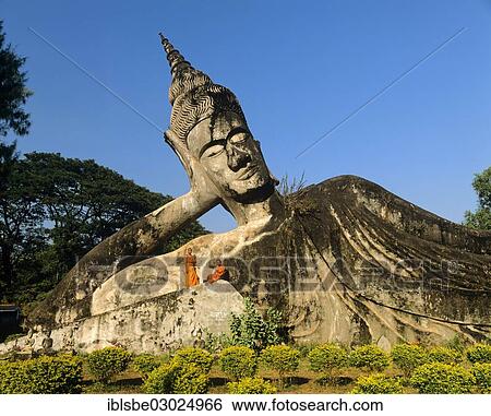 "Reclining Buddha, monks on the sculpture, in Xieng Khuan Buddha Park, Suan Xieng Khuan, Vientiane, Vientiane Province, Laos, Asia" View Large Photo Image Stock Photograph - "Reclining Buddha, monks on the sculpture, in Xieng Khuan Buddha Park, Suan Xieng Khuan, Vientiane, Vientiane Province, Laos, Asia". Fotosearch
