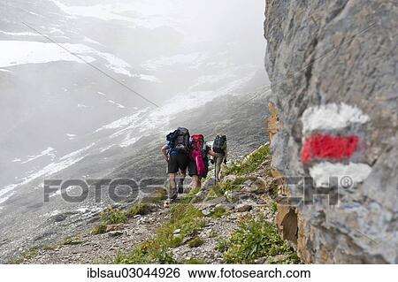 "Red and white markings on rocks, Bear Trek hiking trail, hikers on the way up to the pass in the fog, Pass Hohturli, Kandersteg, Berner Oberland, Berner Alpen, Canton of Bern, Switzerland, Europe" View Large Photo Image Stock Photograph - "Red and white markings on rocks, Bear Trek hiking trail, hikers on the way up to the pass in the fog, Pass Hohturli, Kandersteg, Berner Oberland, Berner Alpen, Canton of Bern, Switzerland, Europe". Fotosearch