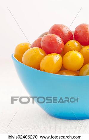 Red and yellow plum tomatoes in a blue bowl View Large Photo Image Stock Image - Red and yellow plum tomatoes in a blue bowl. Fotosearch