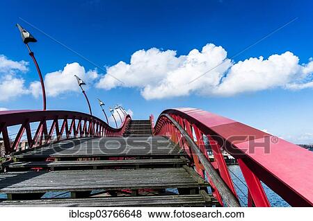 "Red bridge between Borneo Eiland and Sporenburg Eiland, Eastern Docklands, Amsterdam, province of North Holland, The Netherlands, Europe" View Large Photo Image Stock Photo - "Red bridge between Borneo Eiland and Sporenburg Eiland, Eastern Docklands, Amsterdam, province of North Holland, The Netherlands, Europe". Fotosearch