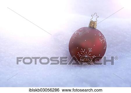 Red Christmas bauble lying in snow View Large Photo Image Stock Photograph - Red Christmas bauble lying in snow. Fotosearch