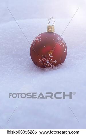 Red Christmas bauble lying in the snow View Large Photo Image Stock Photography - Red Christmas bauble lying in the snow. Fotosearch