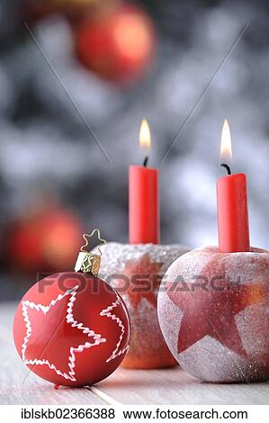 Red Christmas bauble with apples and candles in front of a Christmas tree View Large Photo Image Stock Photo - Red Christmas bauble with apples and candles in front of a Christmas tree. Fotosearch