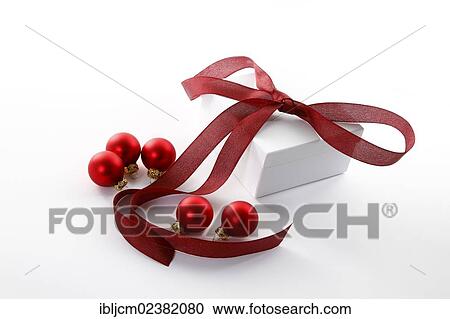 Red Christmas baubles and a present with a red ribbon View Large Photo Image Stock Image - Red Christmas baubles and a present with a red ribbon. Fotosearch