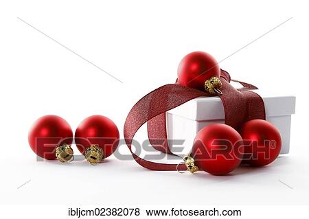Red Christmas baubles and a present with a red ribbon View Large Photo Image Stock Photo - Red Christmas baubles and a present with a red ribbon. Fotosearch