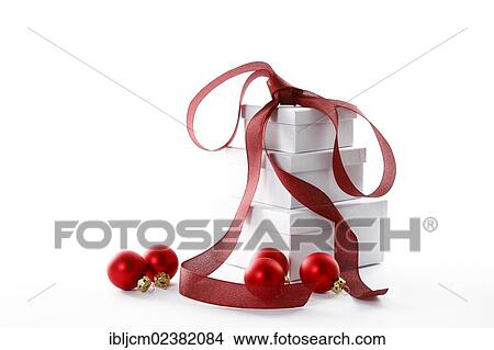Picture - Red Christmas baubles and presents with a red ribbon. Fotosearch