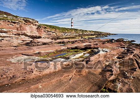 Stock Image - "Red cliffs and lighthouse, Tarbat Ness, Scotland, United Kingdom, Europe". Fotosearch