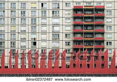 "Red flags for a parade on the 25th anniversary of the Building of the Berlin Wall on Karl-Marx-Allee street, 1986, Berlin, East Germany, GDR, Europe" View Large Photo Image Stock Photo - "Red flags for a parade on the 25th anniversary of the Building of the Berlin Wall on Karl-Marx-Allee street, 1986, Berlin, East Germany, GDR, Europe". Fotosearch