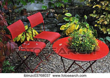 "Red garden chairs and a table, in a garden in autumn, Middle Franconia, Bavaria, Germany, Europe" View Large Photo Image Stock Photo - "Red garden chairs and a table, in a garden in autumn, Middle Franconia, Bavaria, Germany, Europe". Fotosearch