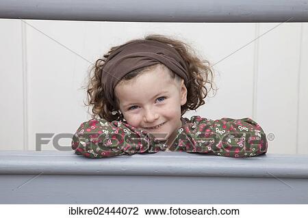 "Red-haired girl, 5 years old, leaning against a railing" View Large Photo Image Stock Image - "Red-haired girl, 5 years old, leaning against a railing". Fotosearch