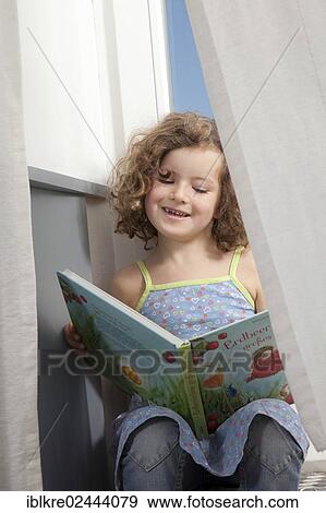 "Red-haired girl, 5 years old, sitting and reading on the stairs of a balcony" View Large Photo Image Stock Photo - "Red-haired girl, 5 years old, sitting and reading on the stairs of a balcony". Fotosearch