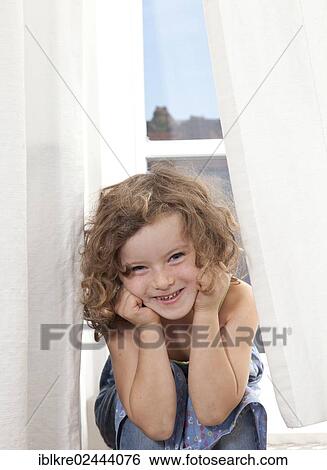 "Red-haired girl, 5 years old, sitting and smiling on the stairs of a balcony" View Large Photo Image Stock Photograph - "Red-haired girl, 5 years old, sitting and smiling on the stairs of a balcony". Fotosearch
