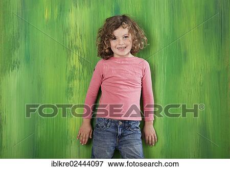 "Red-haired girl, 5 years old, standing in front of a green wall" View Large Photo Image Stock Photo - "Red-haired girl, 5 years old, standing in front of a green wall". Fotosearch