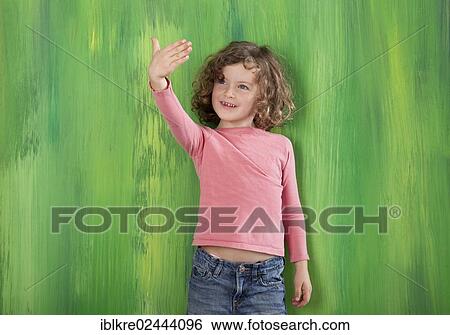 "Red-haired girl, 5 years old, standing in front of a green wall" View Large Photo Image Stock Photograph - "Red-haired girl, 5 years old, standing in front of a green wall". Fotosearch