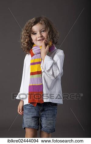 "Red-haired girl, 5 years old, wearing a scarf and jeans" View Large Photo Image Picture - "Red-haired girl, 5 years old, wearing a scarf and jeans". Fotosearch