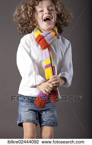 "Red-haired girl, 5 years old, wearing a scarf and jeans" View Large Photo Image Stock Image - "Red-haired girl, 5 years old, wearing a scarf and jeans". Fotosearch