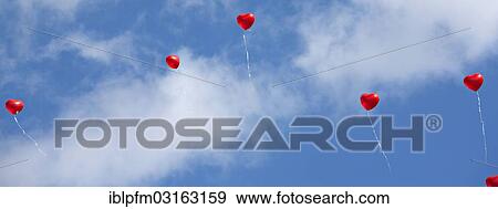 Stock Photo - "Red heart balloons in the sky, Burghausen, Upper Bavaria, Bavaria, Germany, Europe". Fotosearch