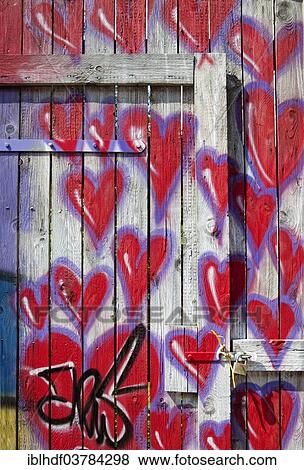 Stock Photo - "Red hearts on a fence, graffiti, Germany, Europe". Fotosearch