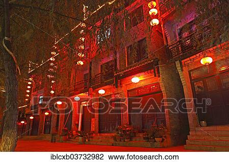 Stock Image - "Red illuminated row of houses at night, historic center, Zhenyuan, Guizhou, China, People's Republic of China, Asia". Fotosearch