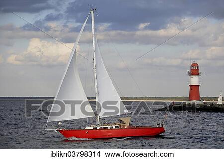 "Red Lighthouse and a red sailing boat, Warnow River estuary, eastern mole, Warnemunde, Mecklenburg-Western Pomerania, Germany, Europe" View Large Photo Image Picture - "Red Lighthouse and a red sailing boat, Warnow River estuary, eastern mole, Warnemunde, Mecklenburg-Western Pomerania, Germany, Europe". Fotosearch