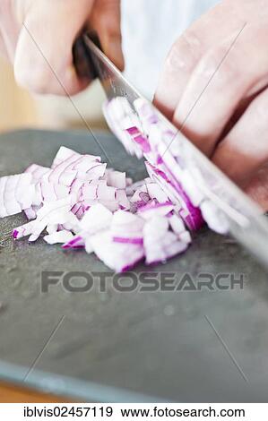 Red onion being cut on a plastic cutting board View Large Photo Image Stock Photo - Red onion being cut on a plastic cutting board. Fotosearch