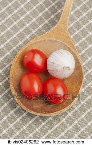 Red plum tomatoes and garlic on a wooden spoon View Large Photo Image Stock Image - Red plum tomatoes and garlic on a wooden spoon. Fotosearch