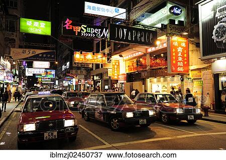 "Red taxis on a street in Tsim Sha Tsui at night, Kowloon, Hong Kong, China, Asia" View Large Photo Image Stock Photo - "Red taxis on a street in Tsim Sha Tsui at night, Kowloon, Hong Kong, China, Asia". Fotosearch