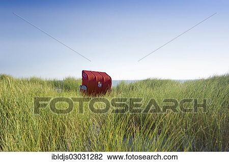 "Red wicker roofed beach chair in the sand dunes, Amrum, Amrum, North Frisian Islands, Schleswig-Holstein, Germany, Europe" View Large Photo Image Stock Image - "Red wicker roofed beach chair in the sand dunes, Amrum, Amrum, North Frisian Islands, Schleswig-Holstein, Germany, Europe". Fotosearch