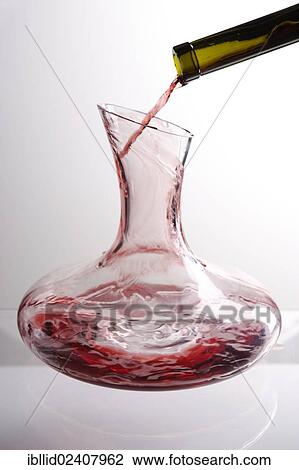 Stock Image - Red wine being decanted. Fotosearch