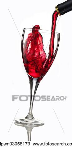 Stock Photo - Red wine being poured into a glass. Fotosearch