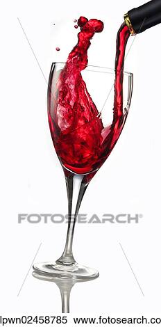 Stock Photography - Red wine being poured into a glass. Fotosearch