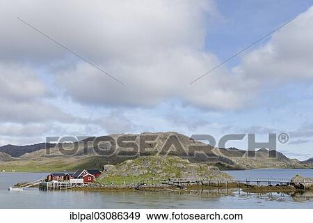 Stock Photo - "Red wooden houses on the coast, Barents Sea, Porsangenfjord, Norway, Europe". Fotosearch