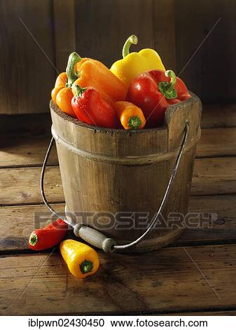 Stock Image - "Red, yellow and orange fresh peppers". Fotosearch