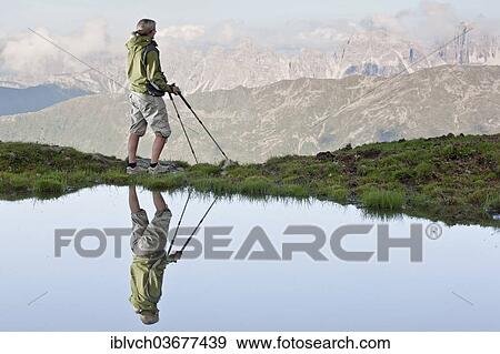 "Reflection of a female hiker small lake looking at the Kalkkoegel range, Sellraintal, Tyrol, Austria, Europe" View Large Photo Image Stock Photo - "Reflection of a female hiker small lake looking at the Kalkkoegel range, Sellraintal, Tyrol, Austria, Europe". Fotosearch
