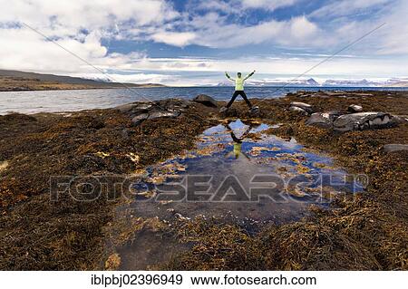 "Reflection of a young woman in a pond, Westfjords, Iceland, Europe" View Large Photo Image Stock Photo - "Reflection of a young woman in a pond, Westfjords, Iceland, Europe". Fotosearch