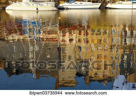 Picture - "Reflection of harbour buildings in the water and yachts, Honfleur, Normandy, France, Europe". Fotosearch