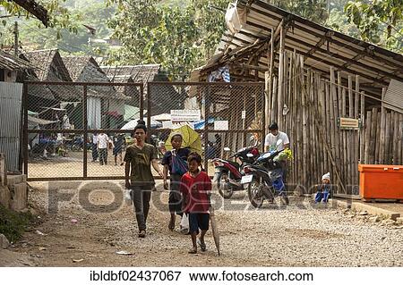"Refugees in front of the main entrance, Mae La refugee camp for the Karen tribe near Mae Sot on the Thai-Burmese border, Northern Thailand, Thailand, Asia" View Large Photo Image Stock Photo - "Refugees in front of the main entrance, Mae La refugee camp for the Karen tribe near Mae Sot on the Thai-Burmese border, Northern Thailand, Thailand, Asia". Fotosearch