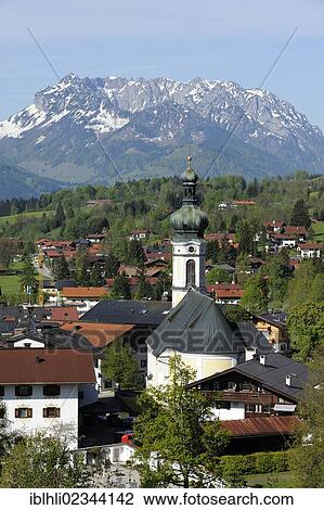 Stock Image - "Reit im Winkl with the Church of St. Pankratius, Zahmer Kaiser mountain at the back, Chiemgau, Upper Bavaria, Bavaria, Germany, Europe". Fotosearch