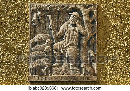 Stock Image - "Relief, Shepherd with sheep, in the Borstei, a heritage protected residential area in the district of Moosach, Munich, Bavaria, Germany, Europe". Fotosearch