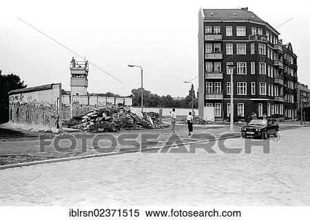 "Remains of the Berlin Wall with a watchtower at Lohmuehlenstrasse road, view from Neukoelln to Treptow, Berlin, Germany, Europe" View Large Photo Image Stock Photography - "Remains of the Berlin Wall with a watchtower at Lohmuehlenstrasse road, view from Neukoelln to Treptow, Berlin, Germany, Europe". Fotosearch